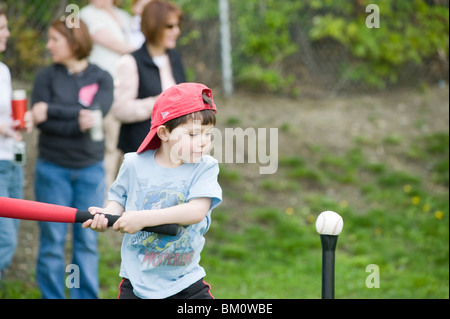 Four and 1/2 year old Hispanic boy participates in his first T-ball practice Stock Photo