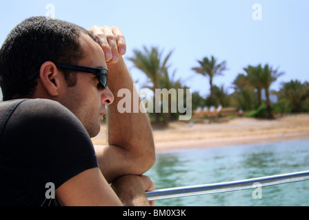 Portrait of a young Egyptian man looking at a boat Stock Photo