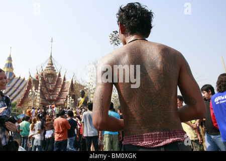 Man in prayer during Wai Kru Day at Wat Bang Phra, a Buddhist temple in Thailand where monks tattoo devotees. Stock Photo