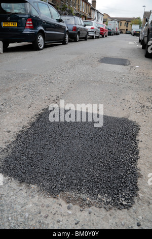 Repaired pot hole in a suburban road in Hounslow, Middx, UK. May 2010.   See BM0P3Y for original pot hole view. Stock Photo