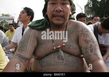 Tattooed devotee during Wai Kru Day at Wat Bang Phra, a Buddhist temple in Thailand where monks tattoo visitors. Stock Photo