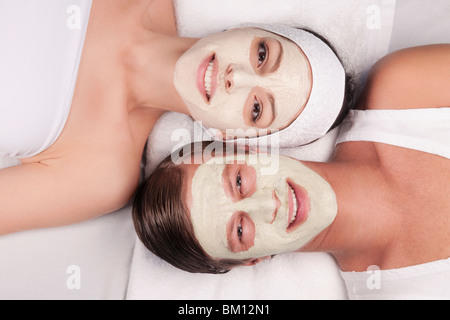 Couple with face pack on their faces Stock Photo