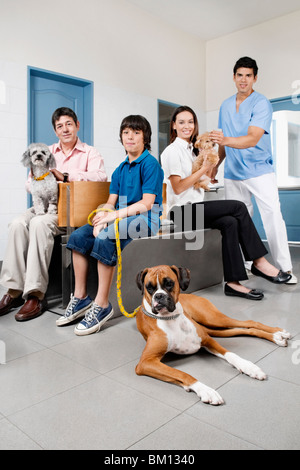 Pets with their owners in a veterinary hospital Stock Photo