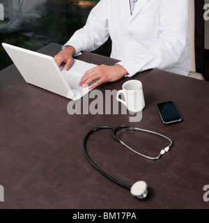 Doctor working on a laptop Stock Photo