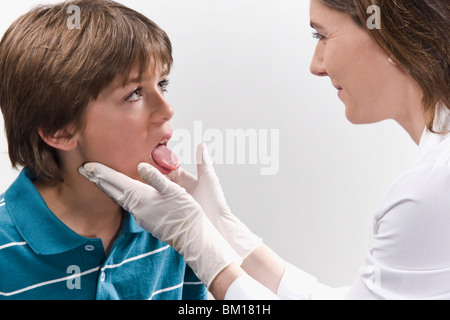 Female doctor examining a boy Stock Photo