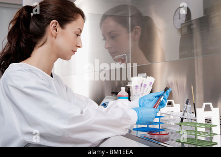 Female doctor holding a medical sample in a laboratory Stock Photo
