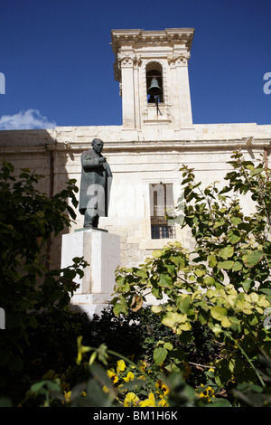 Statue of Paul Boffa, Prime Minister of Malta, 1947 - 1960, with the church of Our lady of Victories behind. Valletta, Malta Stock Photo