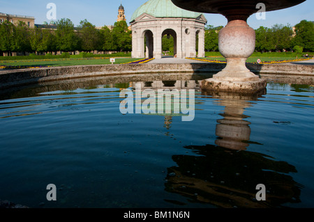 Hofgarten fountain water reflections of Diana's temple and Theatinerkirche church in Munich. Stock Photo