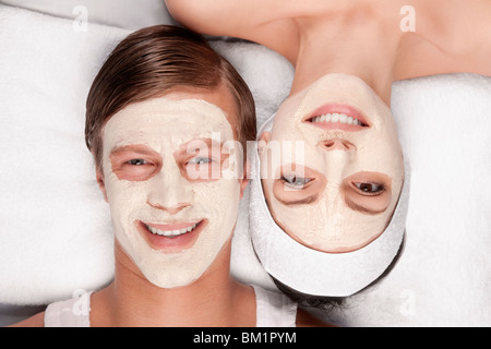 Couple with face pack on their faces Stock Photo