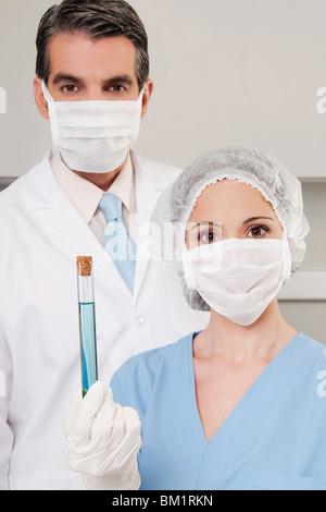 Lab technicians analyzing a sample in a test tube Stock Photo