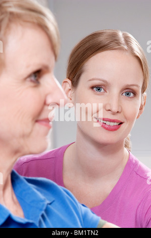 Female physiotherapist smiling with a patient Stock Photo