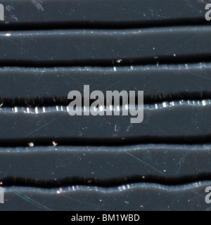 Extreme close-up of the tracks in a vinyl LP record. All sides of the photo are exactly one mm long. Stock Photo