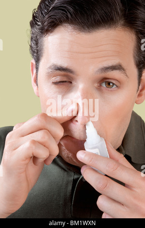 Man using nasal spray Stock Photo