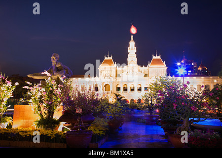 Hotel de Ville and statue of Ho Chi Minh at night Stock Photo