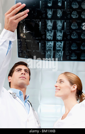 Doctor and a female nurse examining an x-ray report Stock Photo