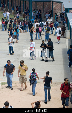 Multi-ethnic crowd of high school students walk through the school courtyard on their way to lunch and classes during a passing period Stock Photo