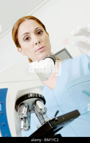 Female lab technician analyzing a sample in a laboratory Stock Photo