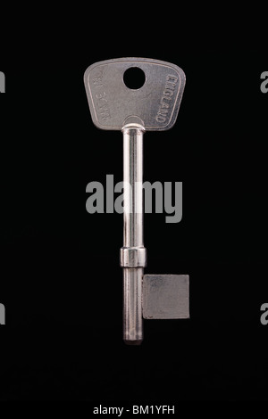 silver blank key isolated on a grey background Stock Photo