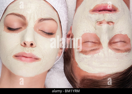 Couple with face pack on their faces Stock Photo