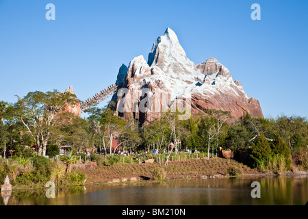Expedition Everest roller coaster cars entering mountain tunnel at Disney's Animal Kingdom in Orlando Florida Stock Photo
