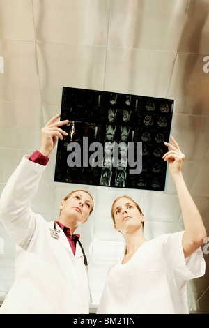 Female doctor and a nurse examining an X-Ray Stock Photo