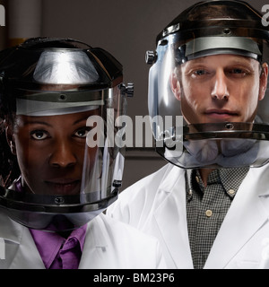 Female and a male doctor wearing protective gears in a laboratory Stock Photo