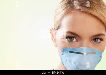 Female nurse wearing a flu mask Stock Photo