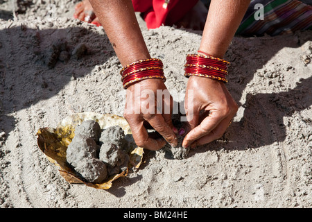 Woman making a ritual puja. Ganges river. Allahabad. India Stock Photo