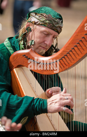 Gainesville FL - January 2009 - Man dressed in period clothing plays harp at Hoggetowne Medieval Faire in Gainesville, Florida Stock Photo