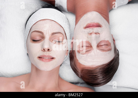 Couple with face pack on their faces Stock Photo