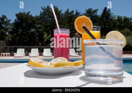 Close-up of assorted drinks at the poolside Stock Photo