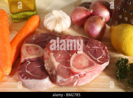 A collection of ingredients for Ossobuco (italian veal shank stew) on a chopping board. Stock Photo