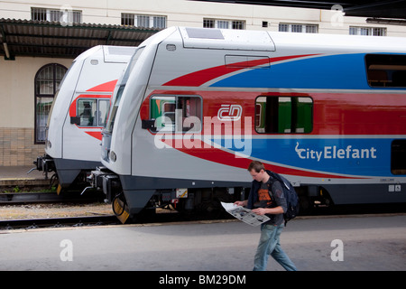 Two Elefant, double-decker inter-city trains, at Masarykovo Nadrazi Station with a man walking past, Prague, Czech Republic Stock Photo