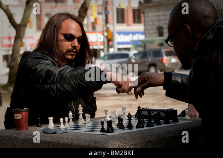 2 man play chess in a park at the corner of Church and Queen street in Toronto April 20, 2010. Stock Photo