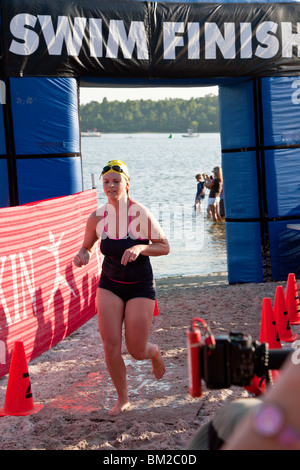 Orlando, FL - May 2009 - Woman crosses finish line in the swimming portion of the Danskin Triathlon Series in Orlando Florida Stock Photo