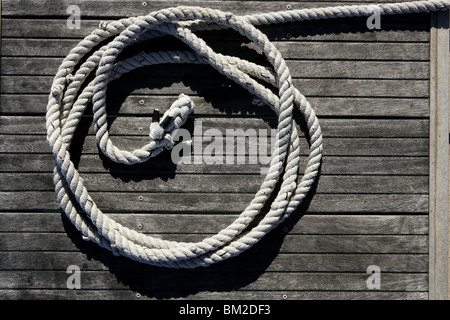 Nautical marine round thread over dried gray teak wood background Stock Photo