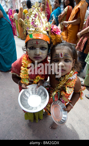 Two street children dressed in the style of Krishna at Diwali festival time, begging, Udaipur, Rajasthan, India Stock Photo