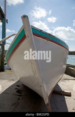 A white wooden boat on the hard in Man O War Cay, Abaco, Bahamas Stock Photo