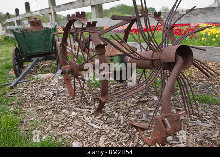 Tulip time festival Dutch Holland Michigan in USA US old rusty potato harvester Windmill Island during a trade fair low angle nobody horizontal hi-res Stock Photo