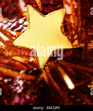 Christmas golden decoration with gold star over red background Stock Photo