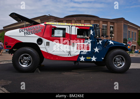 Tulip time festival Dutch Holland Michigan in USA National Guard hummer custom painted with US Flag on a street during trade fair hi-res Stock Photo