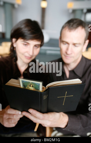 Couple reading the Bible, Paris, France Stock Photo