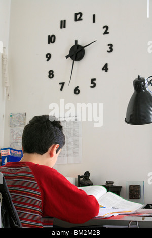 An 11-year old boy doing homework, Paris, France Stock Photo