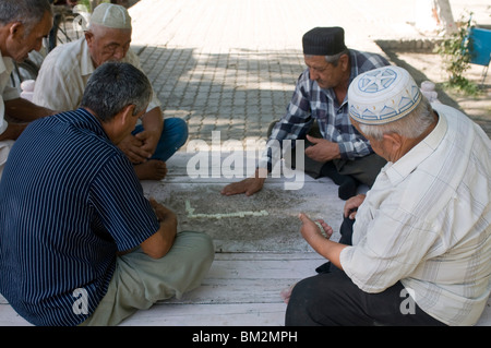 Men playing dominos, Bokhara, Uzbekistan Stock Photo