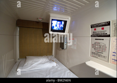 Interior view of single-person sleeping compartment at capsule hotel in Osaka, Japan Stock Photo