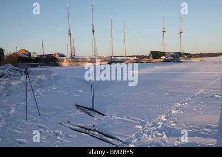 Skis and poles left on the winter tracks over the frozen sea by cross country skiers in Mariehamn Åland Aland Finland archipelago Stock Photo