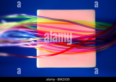 Glowing square with colorful wires such a wired communication metaphor Stock Photo