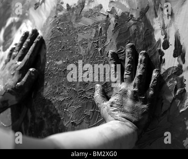 Children dirty hands, painting game, black and white Stock Photo