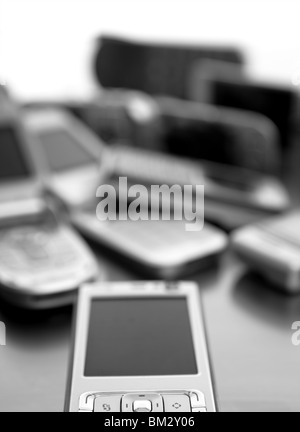 Assorted mixed mobile phones, old, new technology in cell telephones Stock Photo