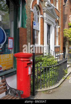 Red post box and house, Dedham Stock Photo